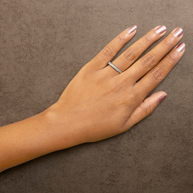 Crafted from polished 14K white gold and adorned with a rhodium plating for added brilliance, this classic band marries...