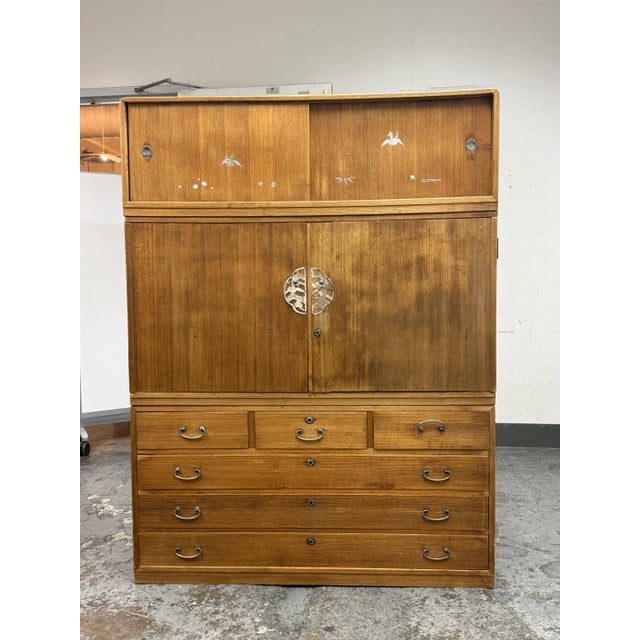 Design Plus Gallery presents a Three Piece Japanese Tansu with Mother of Pearl Inlaid in Kiri Wood. The upper section has...