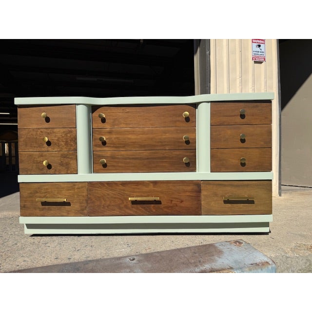 Professionally refinished by Prism Finishes of High Point, North Carolina, this striking Mid-Century Modern triple dresser...