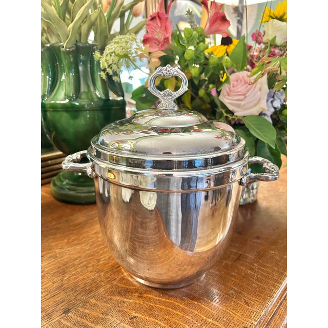 This silver plate ice bucket is by Sheridan and is silver over brass….probably from around 1970. It features handles with...
