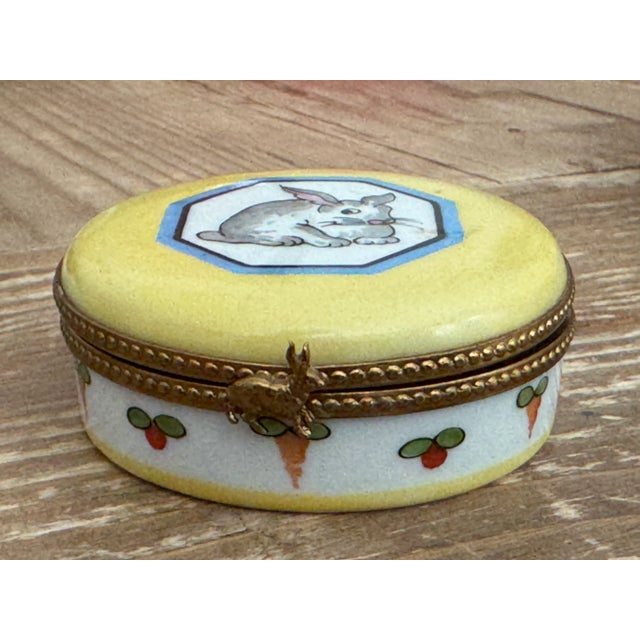 Original limoge round box from France adorned with a bunny on top and cute carrots inside authenticated with the original...