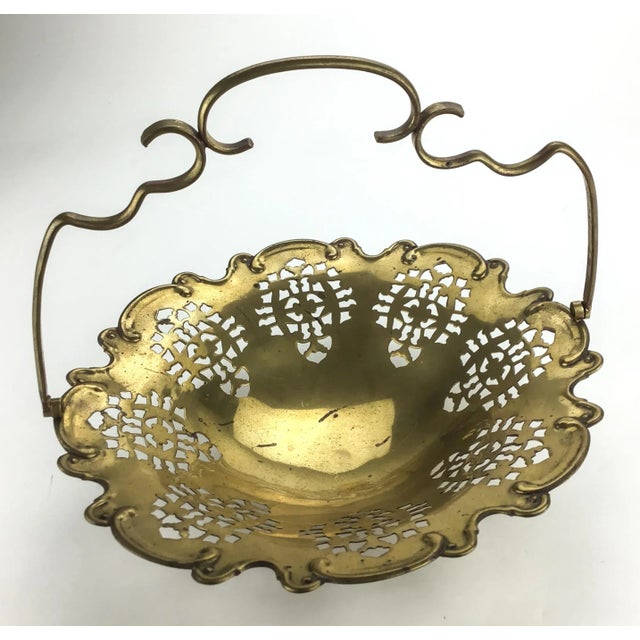 Lovely brass basket made in France. Has a working handle and delicate lace piercings all around the carved edges. Probably...