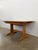 Authentic vintage extendable dining table with 1 built-in leaf. "Windsor" series by Ercol. Model 1157. Maker's label on...