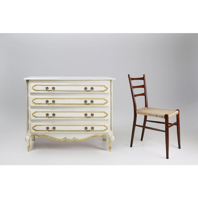 Elegant french louis xv style chest of drawers, crafted in wood and dating from around 1950. This refined four-drawer...