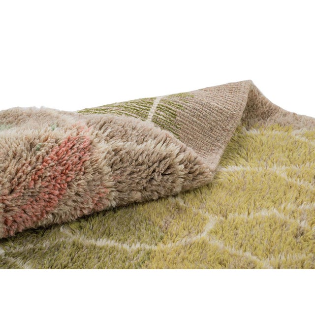 Sophisticated, hand-knotted colorful wool rug featuring a stylish Ivory honeycomb pattern over layered color distribution...
