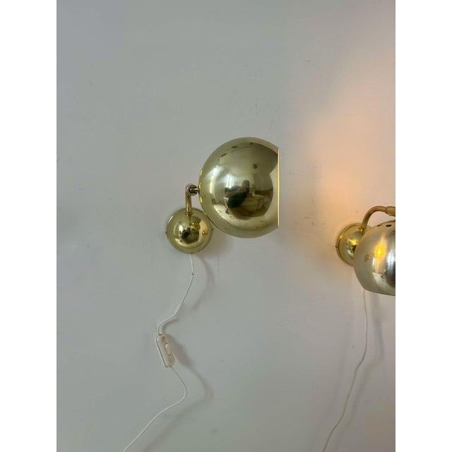 Pair of adjustable brass wall lights produced in Sweden in the 70s. Light effects through the perforations, rare half-...