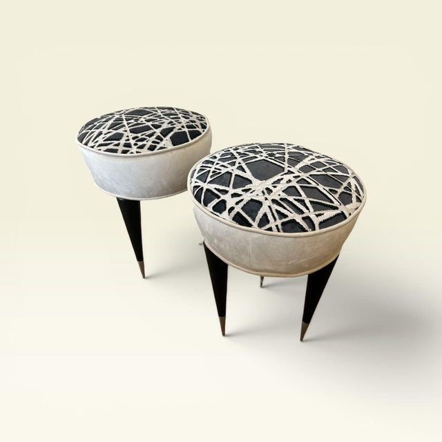 Pair of stools or poufs with a circular profile. Lacquered wood with original mid-century chrome steel detailing. Recently...