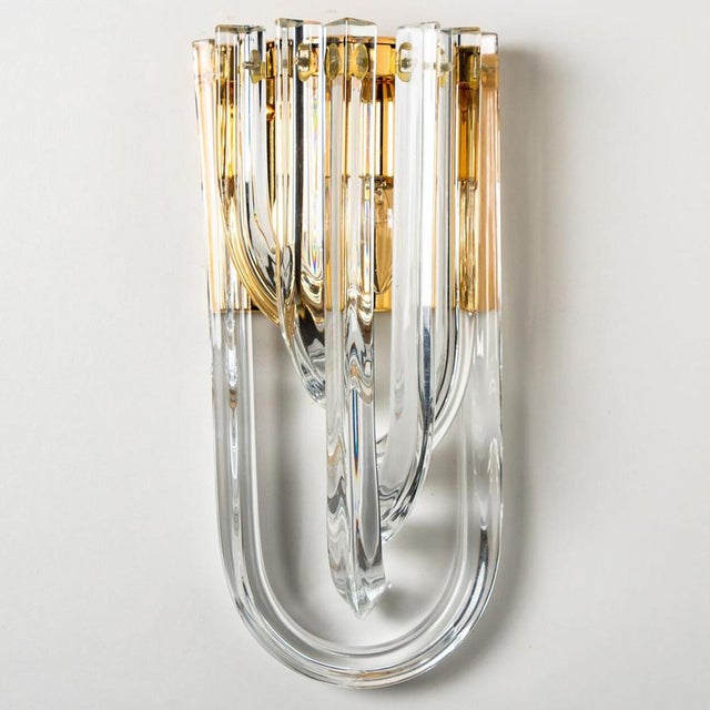 A beautiful and impressive venini wall light, curved crystal glass and gilt brass, italy. The chandelier is made of curved...