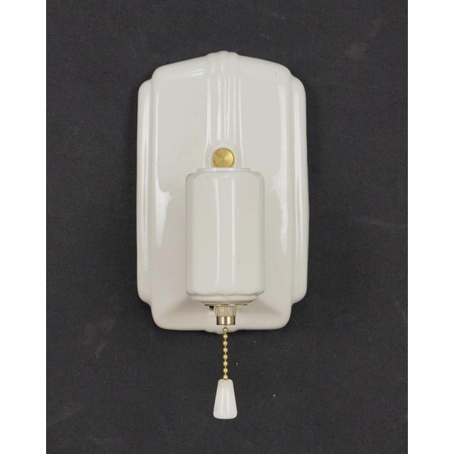 Art Deco white porcelain wall sconces with pull chains. Each sconce requires one Edison style medium base bulb. Good...
