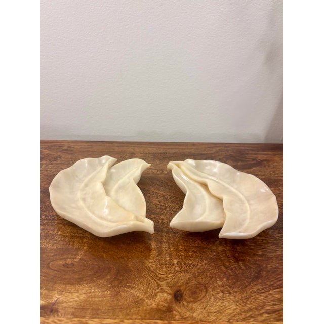 A beautiful pair of vintage Italian alabaster dishes carved in stylized leaf forms. Each piece displays the natural...