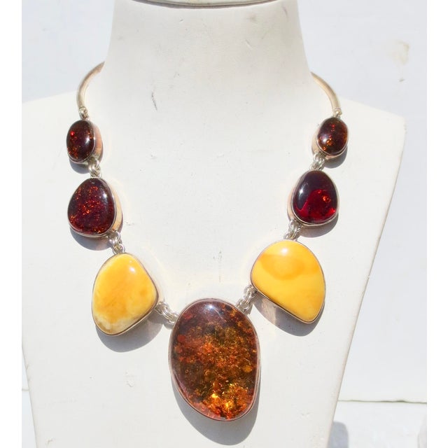 Scandinavian Modern necklace. 3 types of Amber cabochon settings. 7 stones in a chain link connect to a curved silver...