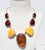 Scandinavian Modern necklace. 3 types of Amber cabochon settings. 7 stones in a chain link connect to a curved silver...
