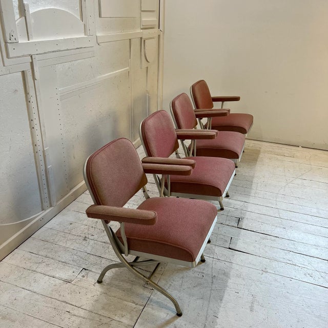 Set of 4 Warren McArthur folding arm chairs with metal base and red cushions. Original tag on chairs. Chair Folded...