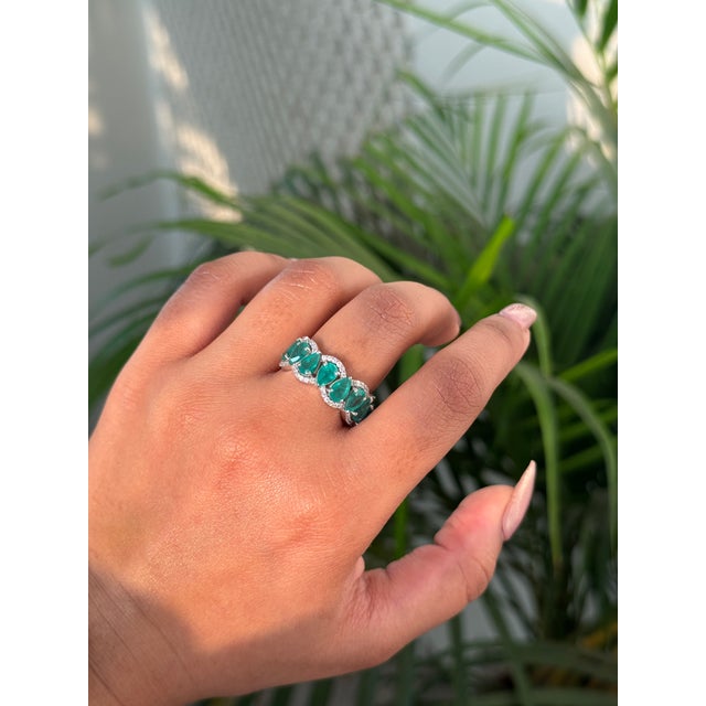 This Half Eternity Band ring features a 2.91 carat pear-cut emeralds set in 14K white gold. Each measuring approximately 6...