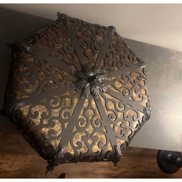 Handmade ceiling mount light from Steven Handelman Studios in Santa Barbara, CA has a black rust finish with an intricate...