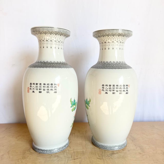 This exquisite pair of vintage Chinese porcelain vases showcases masterful hand-painted artistry, featuring vibrant...