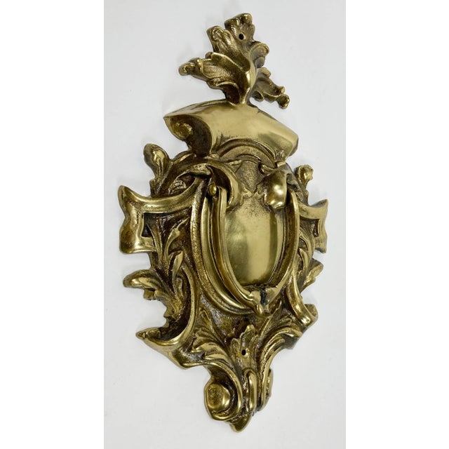 Large vintage lacquered cast brass door knocker with scroll detail. Age wear. Two holes for hanging.