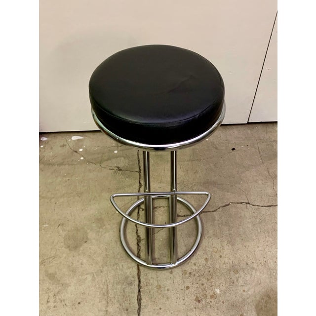 Italian mid-century modern chrome bar stool that are upholstered in leather. These stool are bar height. The chrome is...