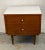 Stylish nightstand crafted in rich walnut, featuring a sleek profile accented by a contrasting white top. Its streamlined...