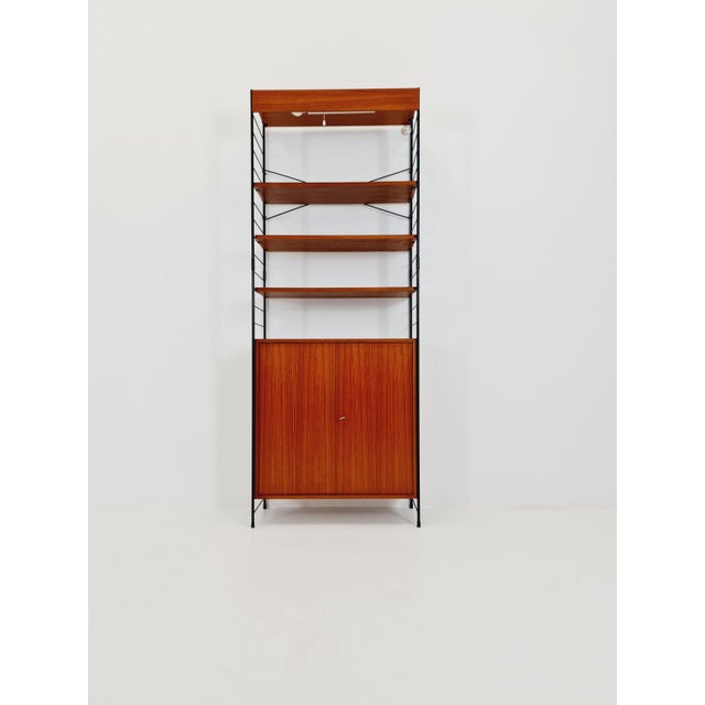 Freestanding String shelving system, bookcase with cabinet Eshe by WHB Germany, 1950s. The bookcase system is in excellent...