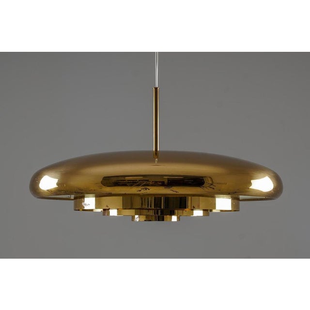 Striking brass pendant designed by Eje Ahlgren for Bergboms in the 1960s. The lamp features a sculptural domed shade with...