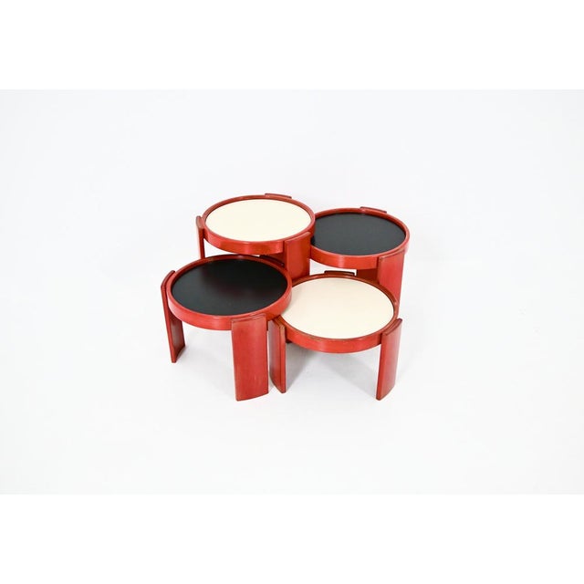 Wooden nesting table. Reversible black and white top. Stamped Cassina. Wear due to time and age of the table. Measures:...