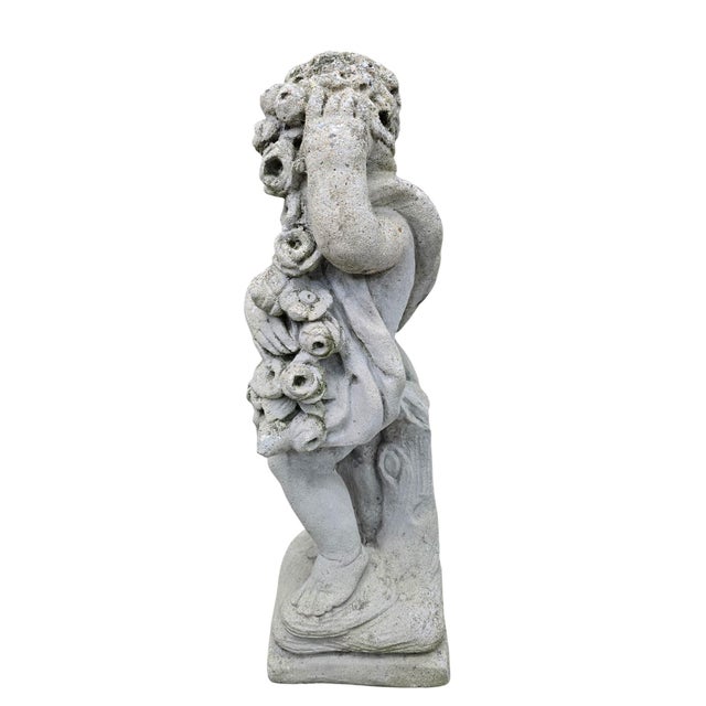 Vintage Classical Garden Cherub Statue Holding Floral Garland A charming classical garden sculpture depicting a cherub, or...