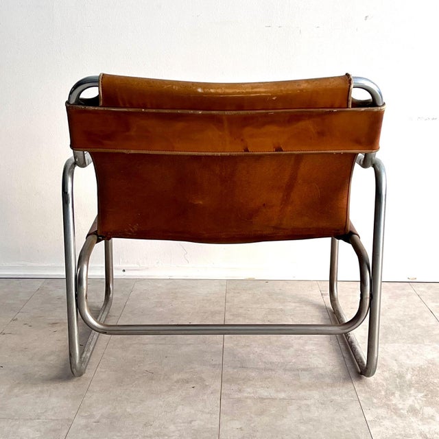 Armchair by Antonello Mosca, chromed steel frame and leather seat, for Produzione Forma, 1970s. The armchair features a...