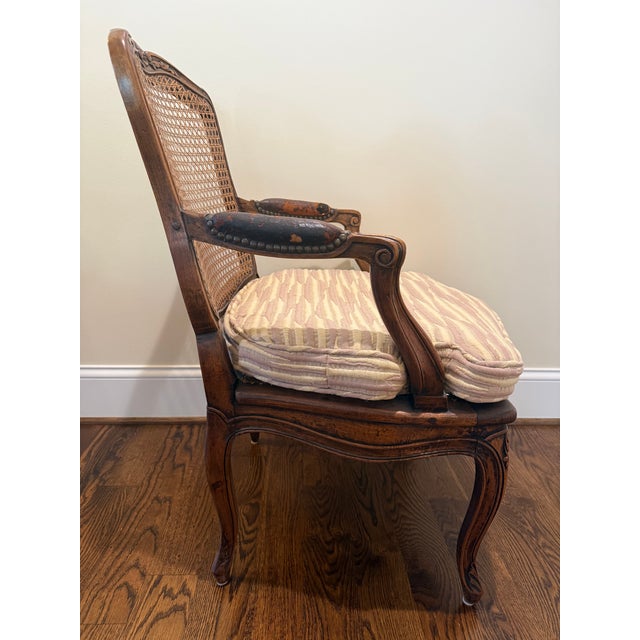 Beautiful carved antique chair with caned seat and back. Caning is in very good condition with the original wood pegs...