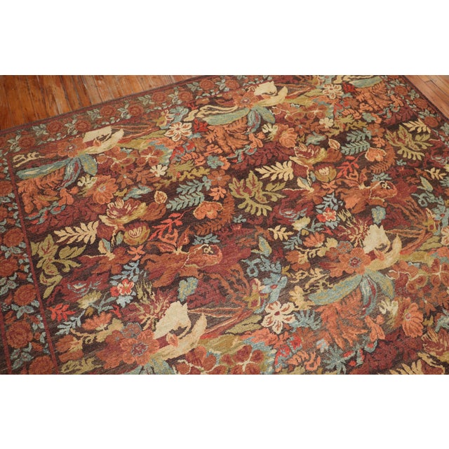 21st century Turkish contemporary wool rug with a an all-over floral design in field and border with autumn colors....