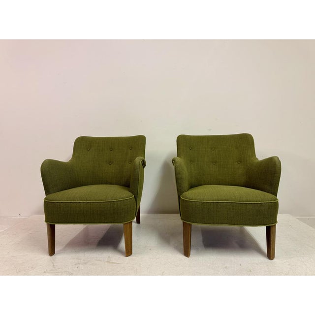 A pair of Model 1748 lounge chairs designed by Peter Hvidt and Orla Mølgaard-Nielsen, Denmark, circa 1950s. These elegant...