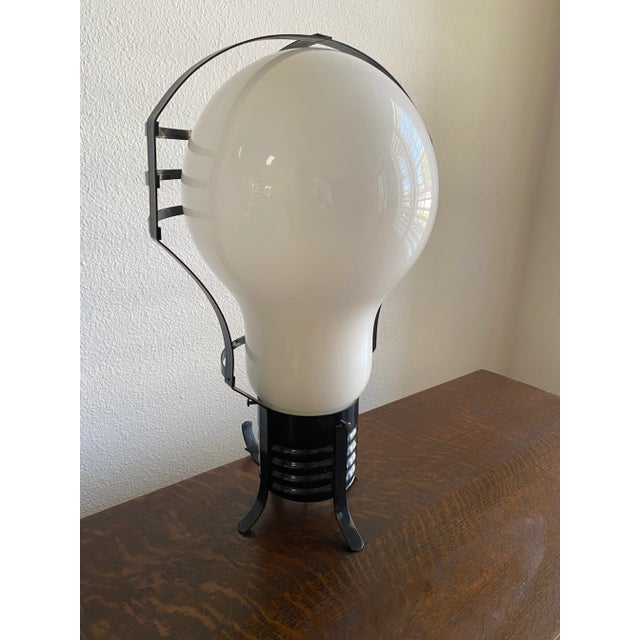 A whimsical and undeniably iconic oversized light bulb lamp, executed on a monumental scale and inspired by the playful...