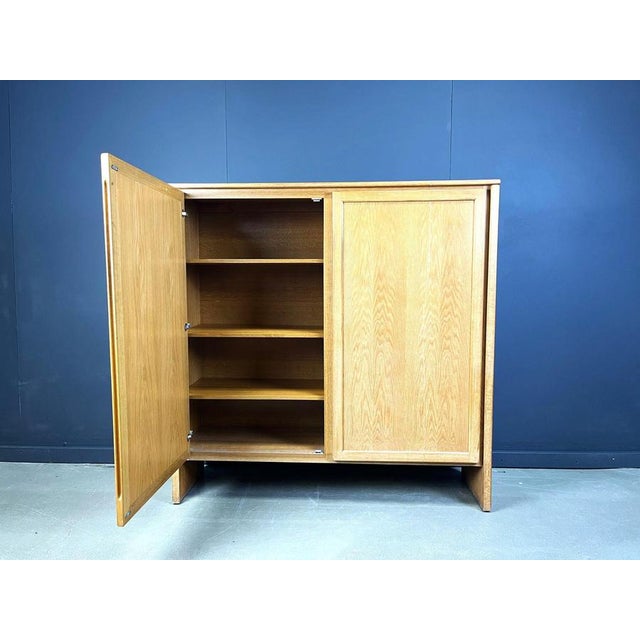 Timeless clear oak 2 door cabinet offering plenty of storage space. Very well crafted piece with integrated carved out...