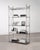 A striking tall French étagère shelving unit crafted from steel featuring a refined architectural frame in the...