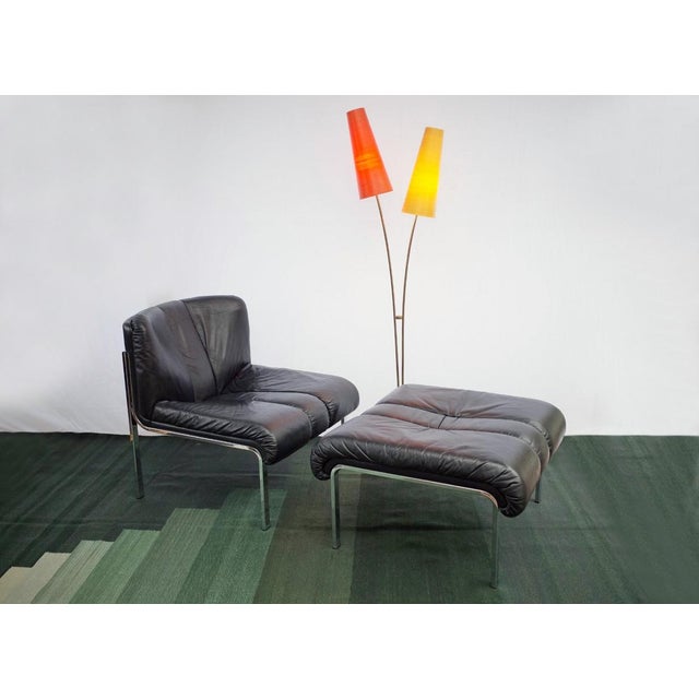 This particular set consists of a black leather armchair and the accompanying stool, which is very rare. This is the...