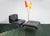 This particular set consists of a black leather armchair and the accompanying stool, which is very rare. This is the...