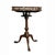 Tilt top table with circular shaped spindled gallery raised on a turned urn form support and three cabriole legs with pad...