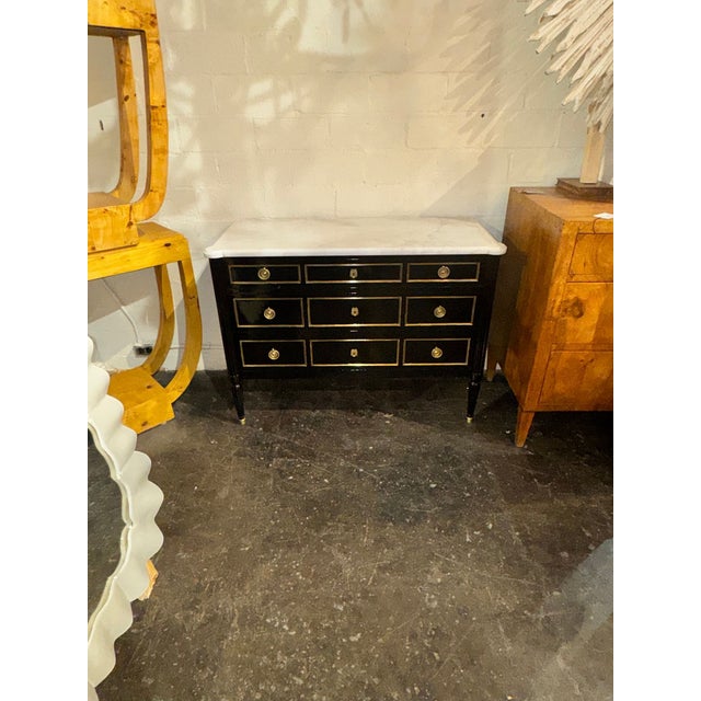 The Vintage French Louis XVI Jansen Style Black Lacquered Chest is a luxurious and elegant piece of furniture. With its...