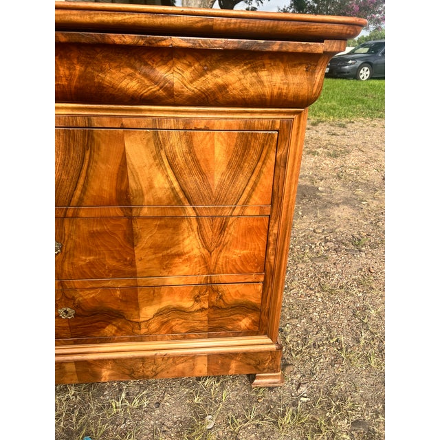 Beautiful 19th-century Louis Philippe commode, expertly crafted in richly figured walnut with striking book-matched veneer...
