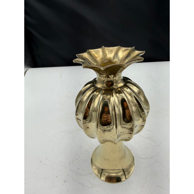 Vintage brass vase with rounded top, ribbed middle and pointed base. The vase has good weight and balance. The vase has...