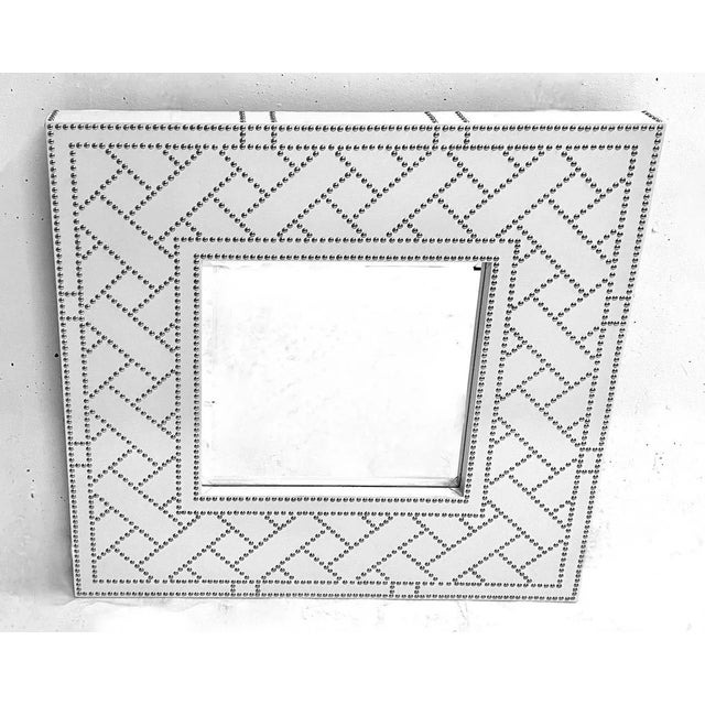 Vintage faux leather and chrome mirror with chrome nailhead accents. Beveled mirror at center. Marked "Global Views” on...