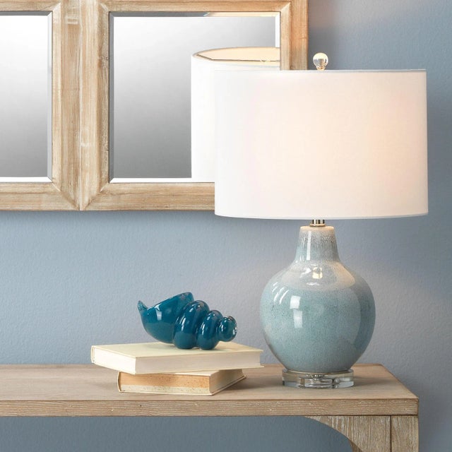 Bring a sense of warmth and serenity to your room with this graceful accent lamp. Crafted of ceramic, each base features a...