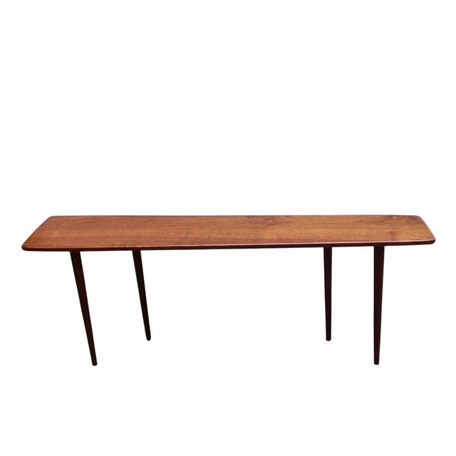 Rare table designed by Johannes Aasbjerg in solid teak with a tapered shape. Thanks to its shallow surface, it can be...