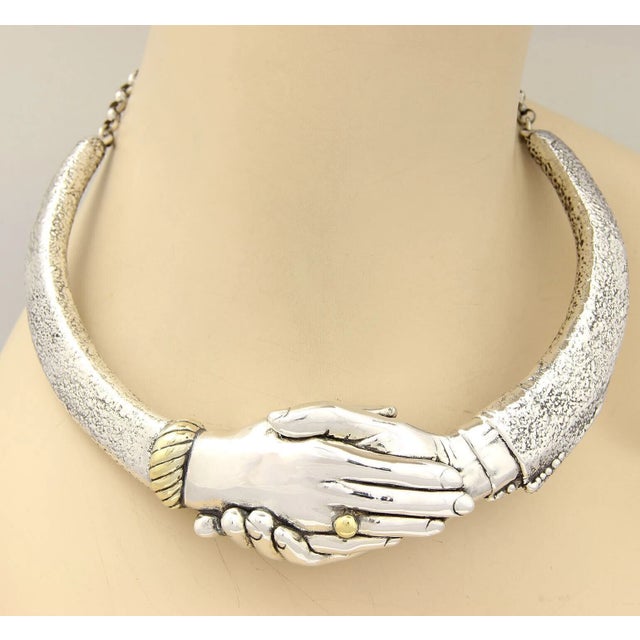 The Yaacov Heller Handshake Choker Necklace is a unique and limited edition piece of vintage jewelry. Crafted from...