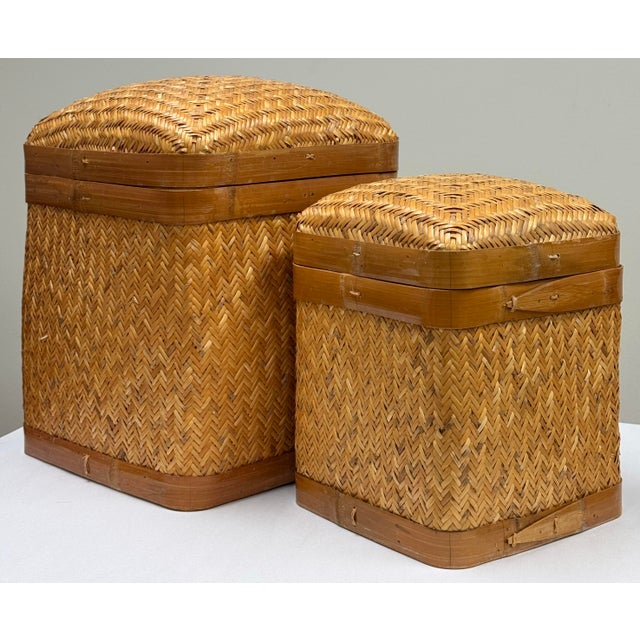 Vintage pair of rattan and woven wicker nesting baskets. Each features a sturdy frame to base and upper lip. Lovely...