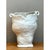 Exemplifying an organic and sculptural aesthetic, this vintage handcrafted ceramic vase features a consistent white glaze...