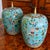 A wonderful pair of brightly colored turquoise cloisonné ginger jars, embellished with the "Hundred Antiques” pattern,...
