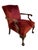 An antique mahogany carved armchair with ball and claw feet, dating approximately from the 18th-19th century and retaining...