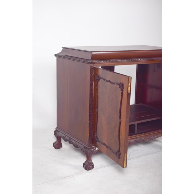 English sideboard with bar. with two front doors and decorative details that highlight the symmetrical design of the...