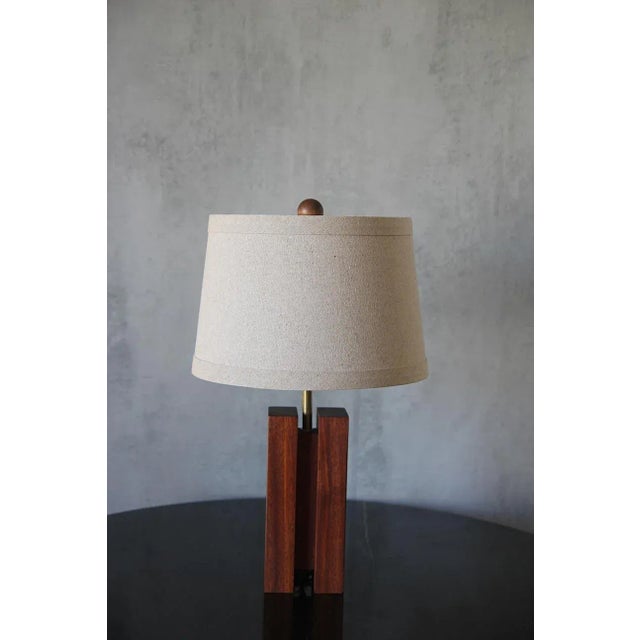 A beautifully crafted sculptural Mahogany reddish-brown blocks form a table lamp having 3 in square cube-shaped wooden,...